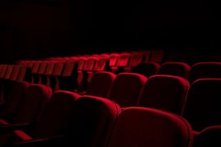 Rows of red theater seats  from the front 