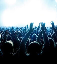 A crowd of people with raised arms during a music concert with an amazing light show. Black silhouettes. 1461816749 concert crowd, concert stage, music show