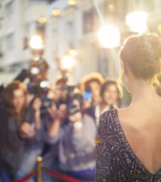 559536551 25-29 years, achievement, actress, arrival, arriving, arts & entertainment, background people, backless, beauty, camera, camera flash, Cape Town, caucasian, celebrity, color image, copy space, day, dress, elegance, evening gown, event, fame, fashion, femininity, film industry, film premiere, focus on foreground, glamour, greeting, hair bun, hello, horizontal, illumination, lens flare, lifestyle, medium group of people, occupation, outdoors, paparazzi, paparazzi photographer, people, photographer, photographing, photography, posing, premiere, red carpet event, red hair, slr camera, South Africa, standing, style, success, the media, vip, waist up, waving, wealth, well-dressed, woman, young adult, young women