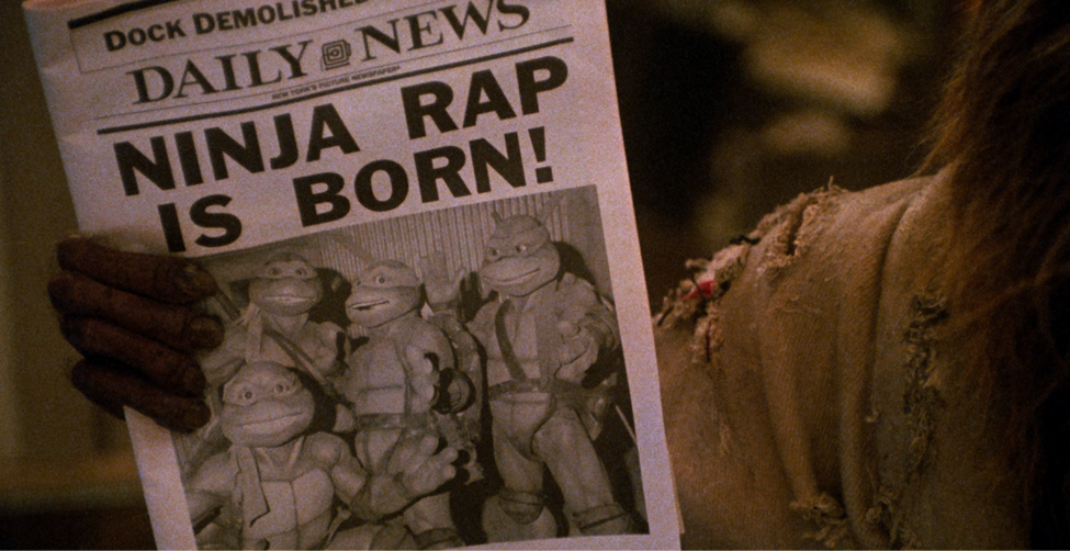 Master Splinter showing the front page of the Daily News paper in TMNT II with the iconic Ninja Rap is Born! front page title 